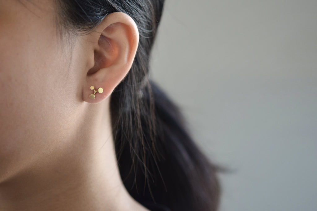 floret gold stud earrings - large - on model